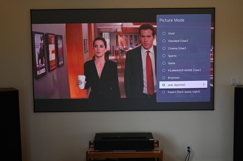 The 'Picture Mode' menu of the LG CineBeam HU915QB UST projector is shown beside a TV drama series.
