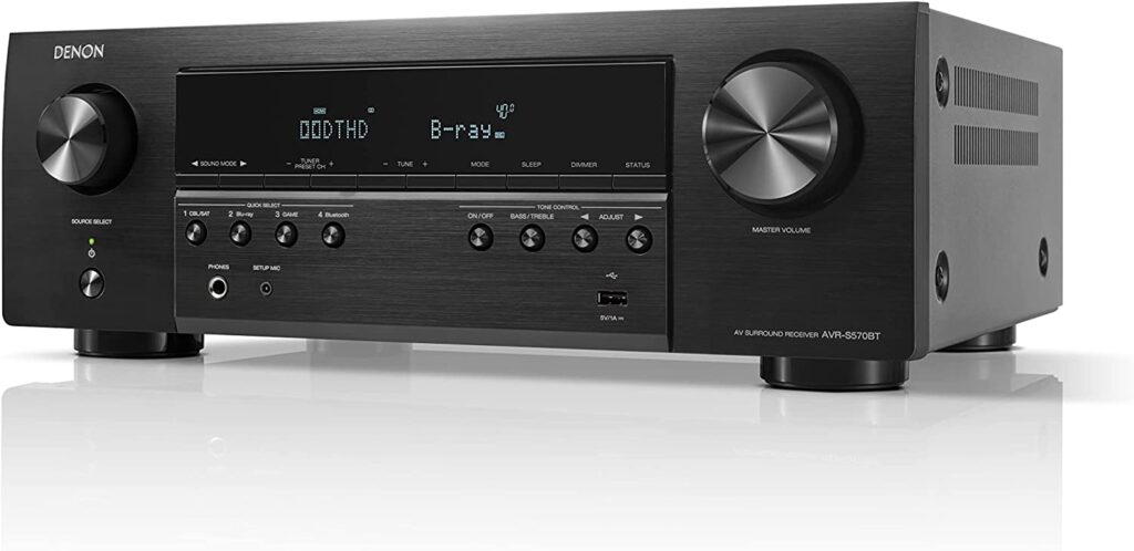 The Denon AVR-S570BT, showing the front buttons, display, and control knobs.