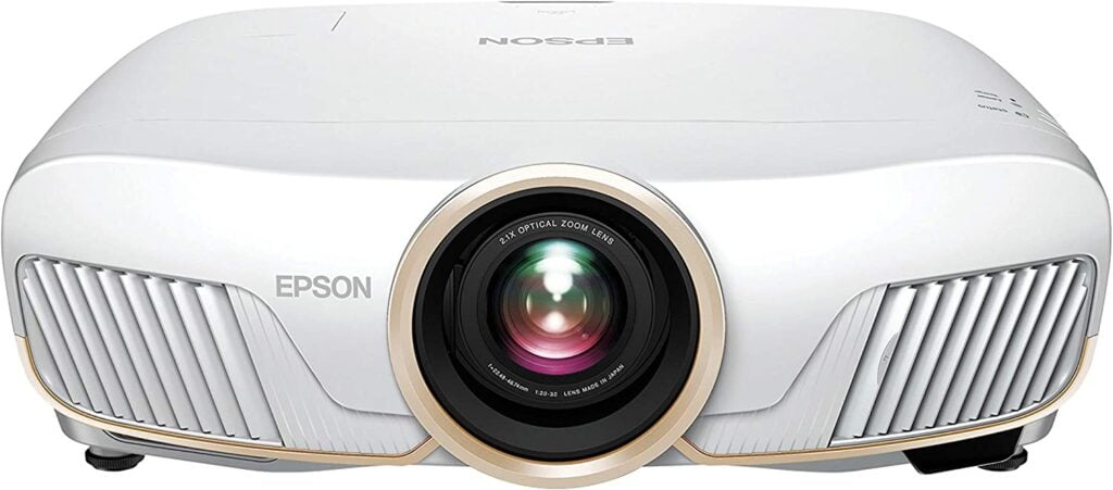 The Epson Home Cinema 5050UB 4K PRO-UHD, one of the best home theater projectors, with a shine on its front lens.