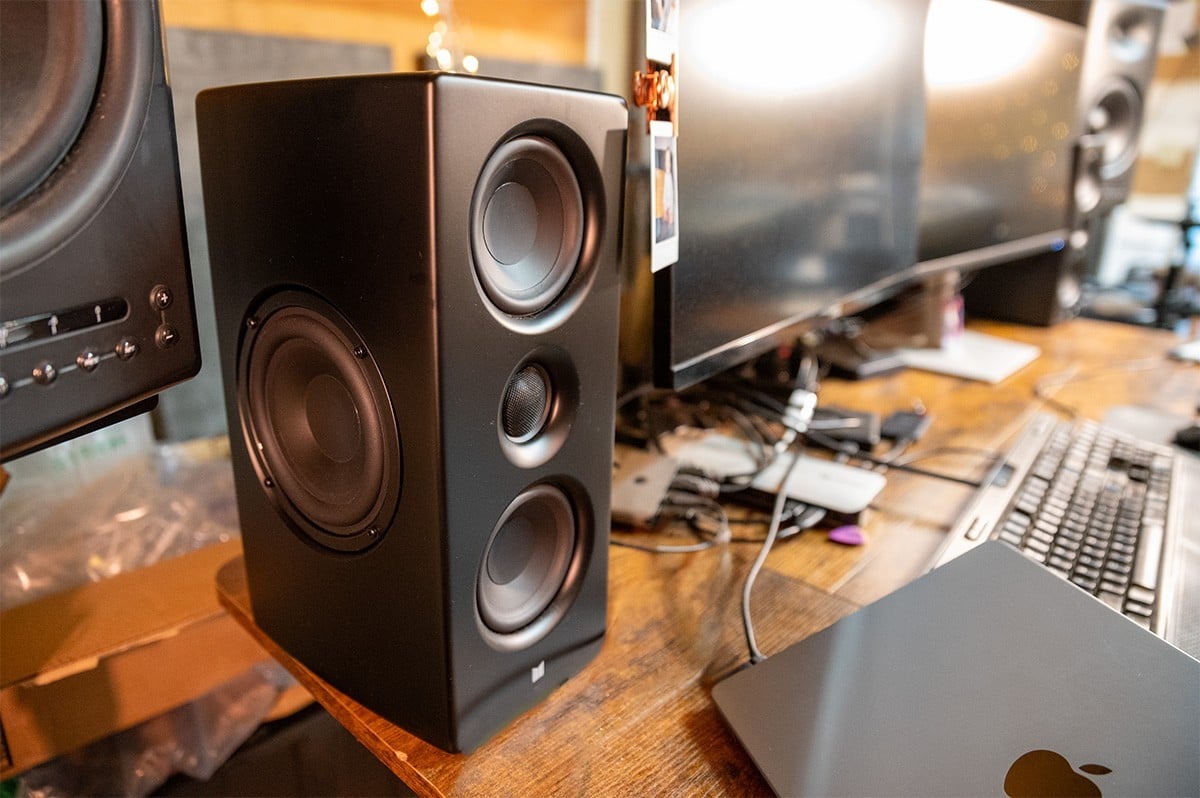 Monolith MTM Desktop speakers being displayed on a desk.